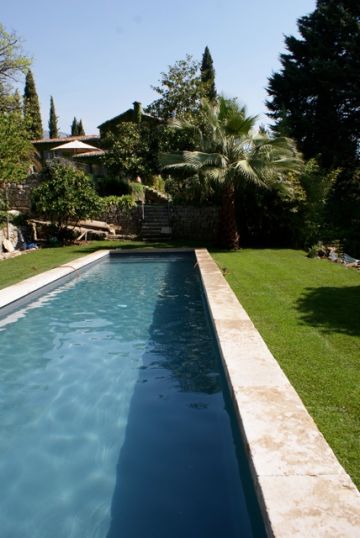 The lap pool is surrounded by a simple natural stone border. No other decking was added, thus preserving this pool's genuinely traditional feel.