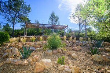 This is a semi-inground pool at the top of a small hill in the midst of a slightly undulating, rocky landscape very typical of Provence.