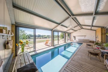 Indoor swimming pool with large, bright patio doors in a gîte near Nantes. This Piscinelle pool won the Gold Trophy for a swimming pool installed by a private individual.