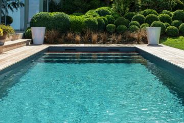 In the late summer light, the pool water is a stunning emerald green.