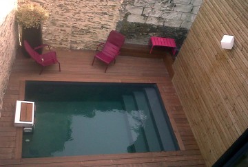 Small swimming pool genuinely surrounded by four walls!