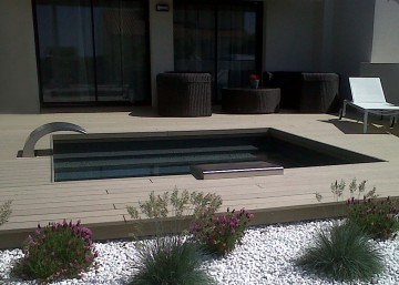 Small contemporary Zen-inspired pool with water curtain and black liner