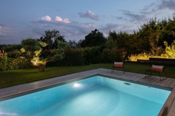 The pool lighting reveals the endless pool unit which can be used for a night-time swim.