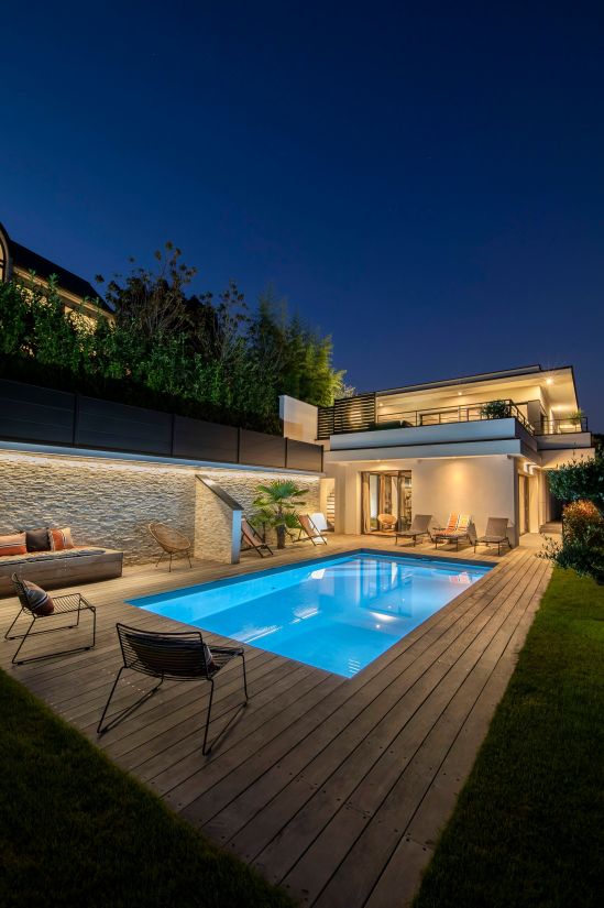 La piscine s'accorde parfaitement à cette maison à l'architecture contemporaine et composent tout deux un ensemble à la fois moderne et accueillant.