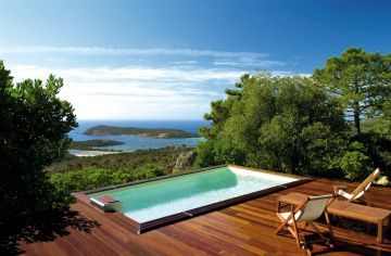 A Cr6 rectangular pool with deck and a stunning view of the bay