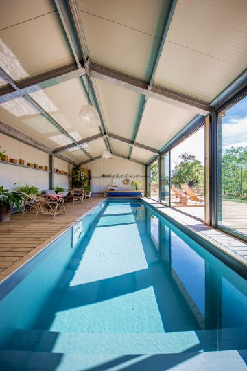 This long indoor lap pool opens up the space and gives new volume to the room.