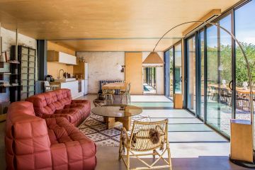 A view from the cosy living room with a small sliver of the lap pool peeking out from the adjoining room.