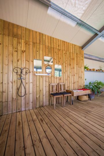 Part of the pool room has been clad with the same wood variety used to build the indoor and outdoor decks. Another reason it all works so well is that this large space is divided into separate sections, making it more aesthetically pleasing.