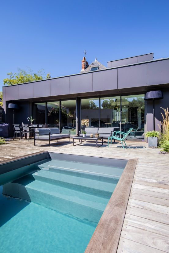 The house extension is ultra-modern with its large patio doors and zinc cladding reminiscent of rooftops in Paris.