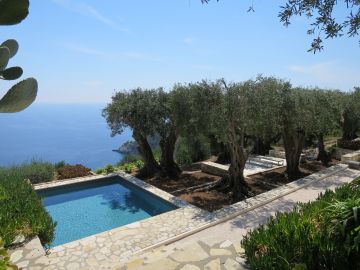 La piscine carrée avec cette vue imprenable sur la mer est bordée d'une oliveraie centenaire.