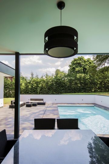 Viewed from the outdoor kitchen, the pool's minimalist look gives the space a Zen-like feel.