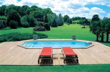 Piscine octogonale Rg avec une petite terrasse avec une vue sur la forêt et la campagne