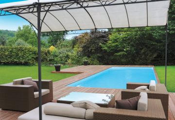 A Cr10 rectangular pool with deck surrounded by lawn in a garden