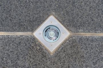 The LED spotlights embedded in the tiling around the pool highlight this fantastic build at night.