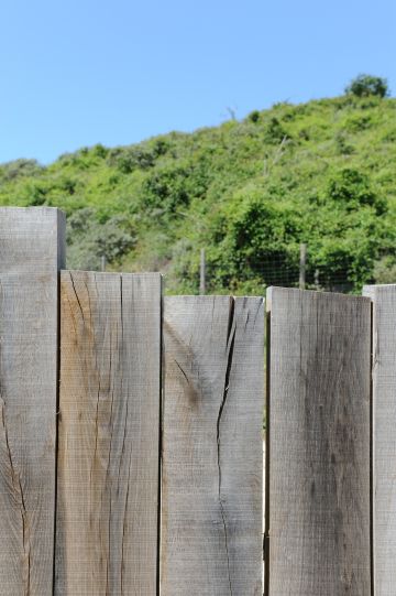 The wooden fence is entirely consistent with the house and pool, blending in perfectly with this idyllic natural setting.