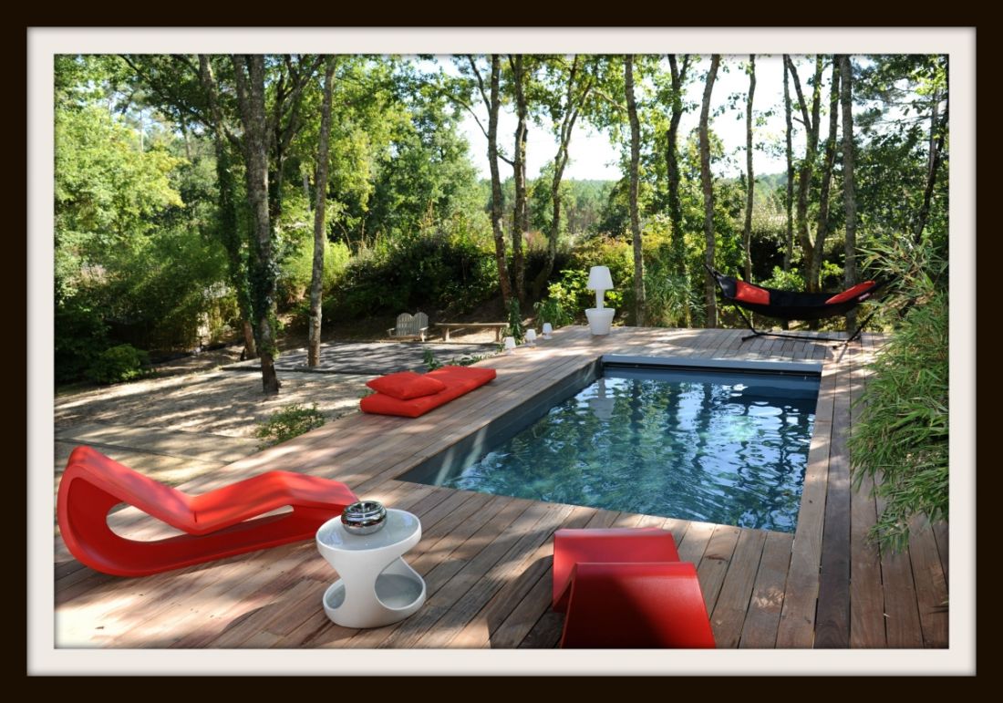 2015 Piscinelle Gold award - Eco-pool surrounded by woodland with a highly contemporary feel due to its unobtrusive pit-mounted slatted cover and bright red furniture.